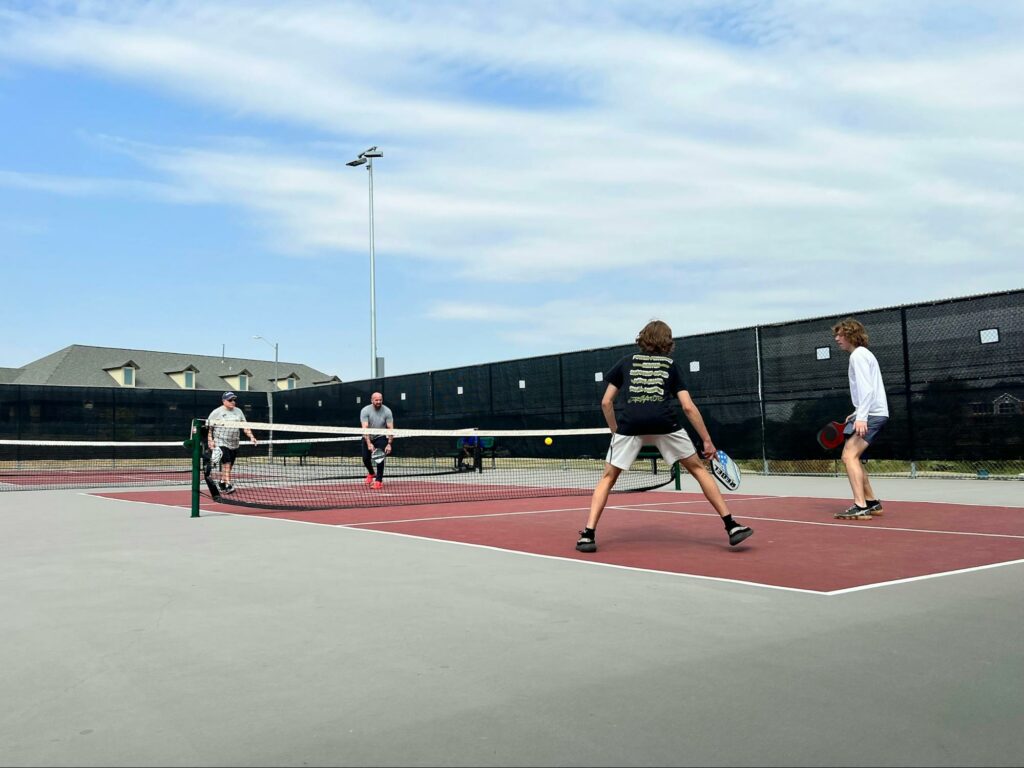 men playing pickleball outdoors in the daytime